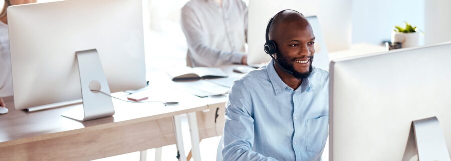 Call center, computer and consulting with black man in office for customer service, technical suppo.